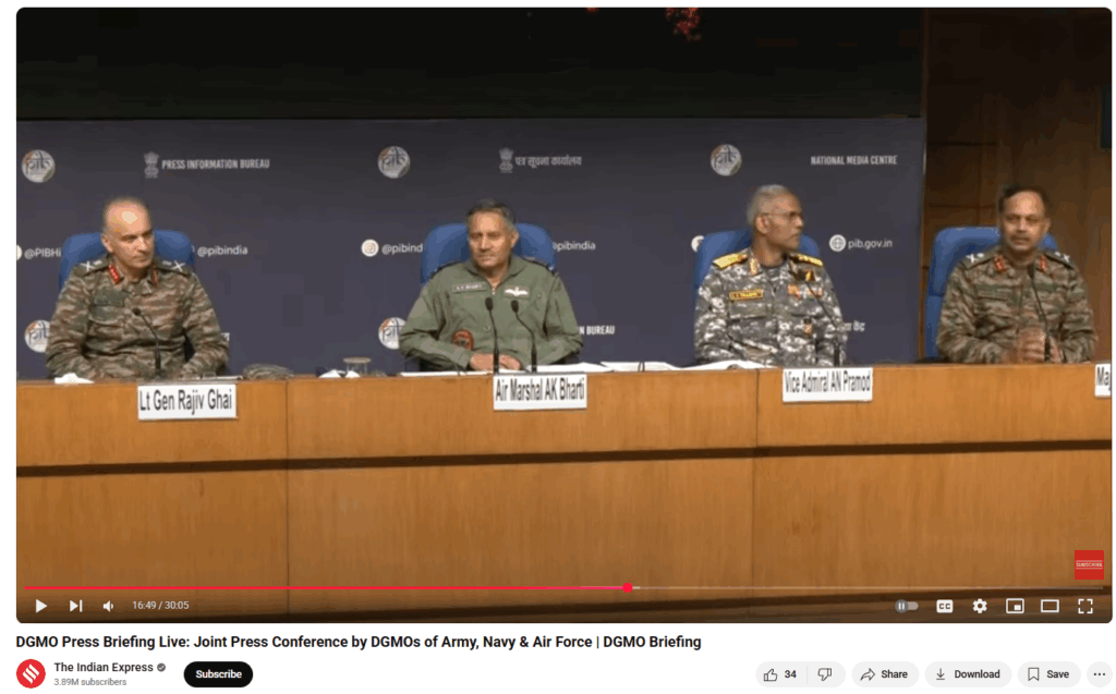 Screenshot from a live DGMO press briefing hosted by the Indian Army, Navy, and Air Force, featuring senior military officials including Lt Gen Rajiv Ghai, Air Marshal AK Bharti, Vice Admiral AN Pramod, and Maj Gen. The press conference is held at the National Media Centre, with branding from the Press Information Bureau (PIB) and social media handles visible in the background. The image is taken from a YouTube livestream by The Indian Express, showcasing the official joint communication from India’s top defense leadership amid ongoing misinformation about Rafale jet losses.